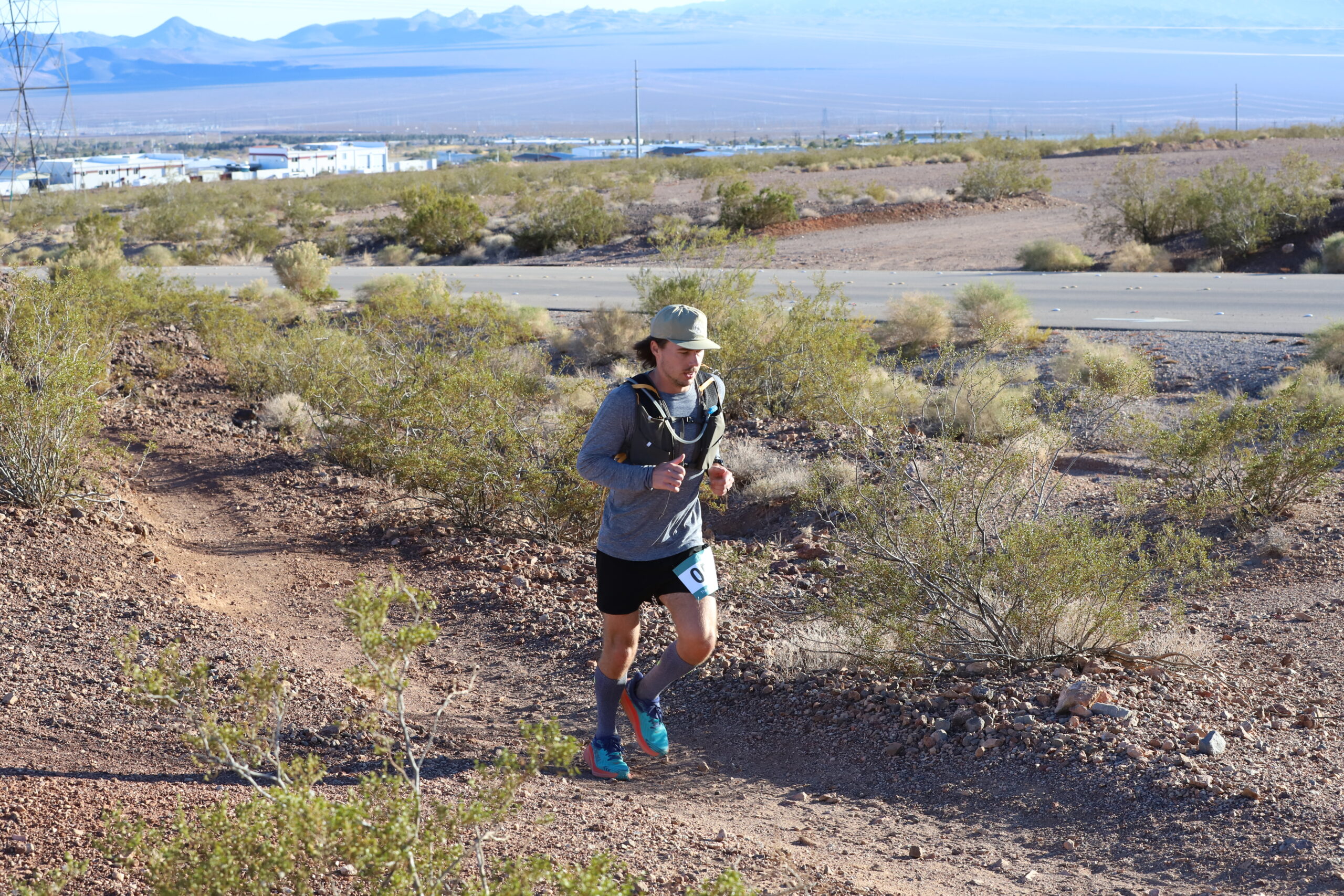 Trail runner running the bootleg boogie ultra marathon in the mojave desert, nevada.